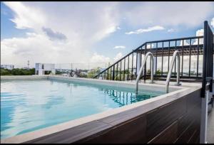 a swimming pool on top of a building at Fast WIFI/5 min beach/Private Parking in Playa del Carmen