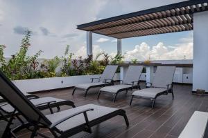 a group of chairs sitting on a patio at Fast WIFI/5 min beach/Private Parking in Playa del Carmen