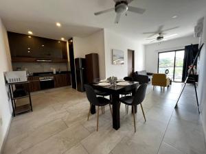 a dining room and kitchen with a table and chairs at Fast WIFI/5 min beach/Private Parking in Playa del Carmen