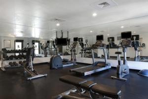 a gym with several tread machines and a mirror at Staybridge Suites Tallahassee I-10 East, an IHG Hotel in Tallahassee