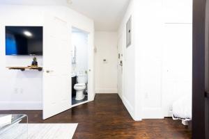 a white bathroom with a toilet and a sink at 69-4C PRIME Lower East Side 1br Apt Brand New in New York