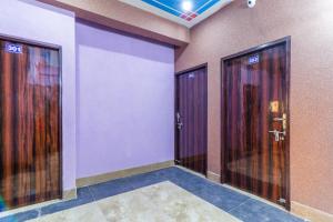 a row of elevators in a room with doors at OYO Mastic Marvell in Noida