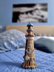 a small lighthouse sitting on top of a bed at Ancora qui, nel Golfo dei Poeti in La Spezia