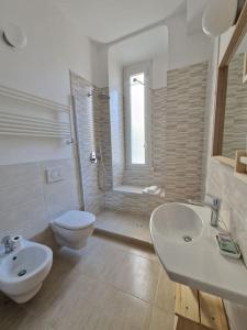 a bathroom with a toilet and a sink and a shower at Ancora qui, nel Golfo dei Poeti in La Spezia