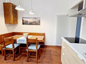 a kitchen with a table and chairs in a kitchen at Ancora qui, nel Golfo dei Poeti in La Spezia