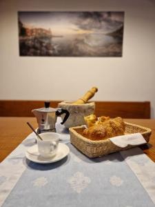 a table with a basket of bread and a cup of coffee at Ancora qui, nel Golfo dei Poeti in La Spezia