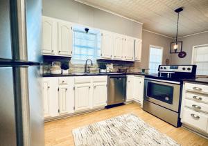 a kitchen with white cabinets and stainless steel appliances at Windmill Inn in Abilene