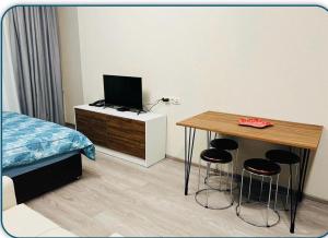 a bedroom with a bed and a desk with stools at Crystal New Resort in Bakuriani