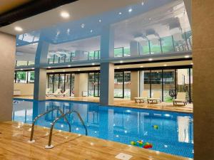 a large swimming pool in a large building at Crystal New Resort in Bakuriani