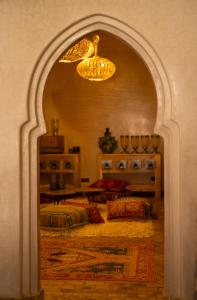 an archway into a living room with a bed at Eden Boutique Hotel in Tamellalt