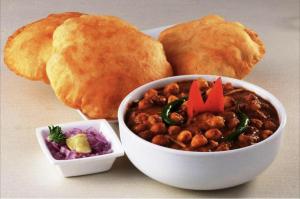 a bowl of food with a bowl of beans and bread at HOTEL COSTA DEL in Mumbai