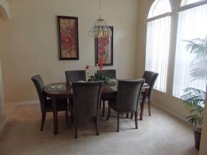 a dining room with a wooden table and chairs at 35 - Fabulous 4 Bedroom Villa with South Facing Pool in Orlando