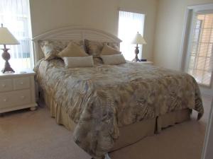 a large bed in a bedroom with two lamps and two tables at 35 - Fabulous 4 Bedroom Villa with South Facing Pool in Orlando