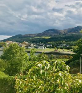 a view of a river with mountains in the background at Grey Heron Townhouse in Newcastle