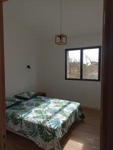 a bedroom with a bed and a window at Campagne et Mer in Perpignan