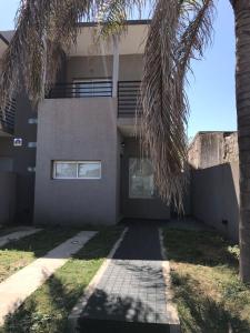 a house with a palm tree in front of it at Rio Victoria in Victoria