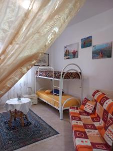 a room with two bunk beds and a couch at MiraErice in Napola