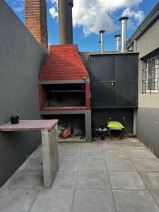 a pizza oven with a red roof on a building at Lo de pame y Fran in Tandil