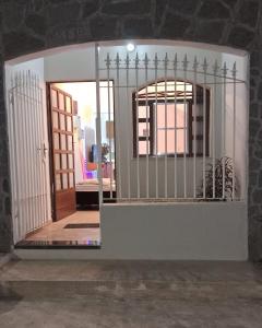 a gate in a room with a door and a room at kitnet em São João Del Rei, a 11km de Tiradentes MG in São João del Rei