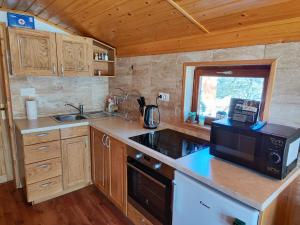 a kitchen with a sink and a stove top oven at Peace Creek in Slunj