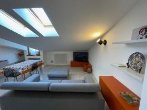 a living room with a couch and a table at Elia Loft in Riva del Garda