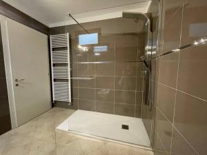 a bathroom with a shower with a glass door at Elia Loft in Riva del Garda