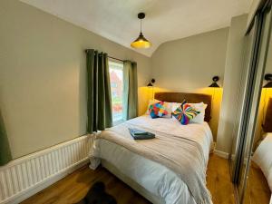 a bedroom with a large bed with a window at Home in Sheffield with King/Twin bed in Longley