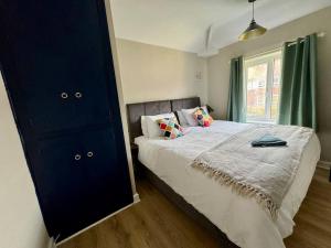 a bedroom with a large bed and a window at Home in Sheffield with King/Twin bed in Longley