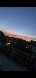 a view of a city at sunset from a balcony at Walle Retreat Zentral&Gemütlich in Bremen