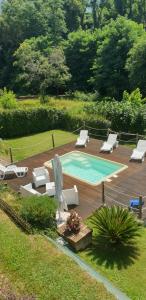 uma piscina com espreguiçadeiras e um deque em Casa vacanze Lulù em Camaiore