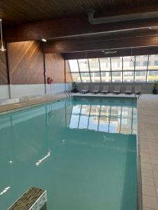 a large swimming pool with blue water in a building at Atlantica Hotel Halifax in Halifax