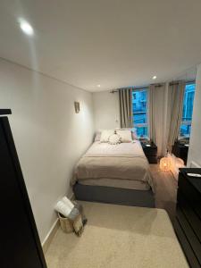a bedroom with a bed and a window at LondonEYE private bedroom in shared flat in London