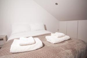 a bed with white towels on top of it at Luxury London Townhouse - Hidden Gem in London