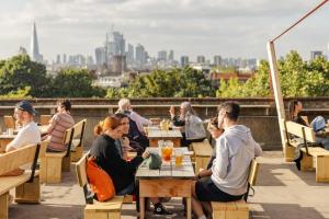 a group of people sitting at tables on a roof at Luxury London Townhouse - Hidden Gem in London