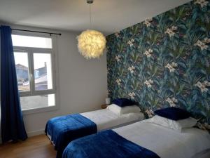 En eller flere senge i et værelse på Appartement plein centre de Valence d'Agen