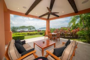 a screened in porch with a table and chairs at Los Suenos Resort Terrazas 1A in Herradura