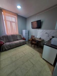 a living room with a couch and a table at ARMONIE AIRPORT HOSTEL in Băcioi