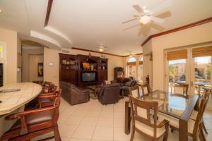 a living room with a ceiling fan and a dining room at Los Suenos Resort Bella Vista 2C in Herradura