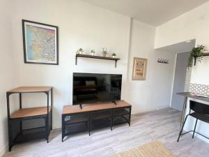 a living room with a fireplace and a tv at Little Good time in Marseille