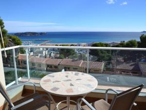 a balcony with a table and chairs and the ocean at Casa Mediterranea - L'Estartit, Roca Maura - ES-323-70 in L'Estartit