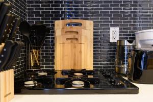 a kitchen stove with a wooden block on top of it at 69-5A Modern Lower East Side 1BR Apt BRAND NEW in New York