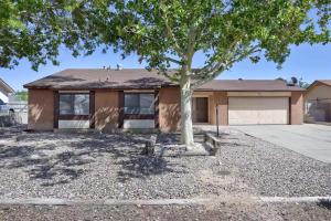 a house with a tree in front of it at Buckboard House in Rio Rancho