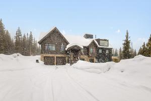 a house is covered in snow at The Waterfall House in Keystone