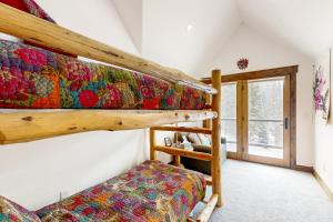 a bedroom with two bunk beds and a window at The Waterfall House in Keystone