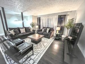 a living room with a couch and a table at Cozy & Sleek 3 bd 3 b Sleeps 8 in Millard
