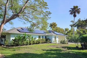a house with solar panels on the roof at Away from it All Abode in Sanibel