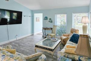 a living room with a couch and a table at Away from it All Abode in Sanibel