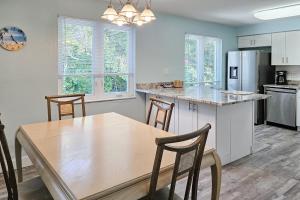 a kitchen and dining room with a wooden table and chairs at Away from it All Abode in Sanibel