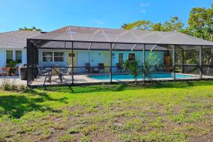 a house with a tent over a swimming pool at Away from it All Abode in Sanibel