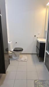 a bathroom with a toilet and a sink at Chambres sur Cergy in Cergy